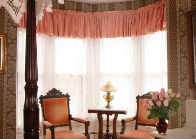 Prince of Wales bay window sitting area with two upholstered Victorian chairs