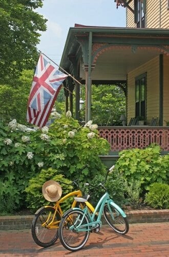 Photo of two Queen Victoria bicycles parked on The Queen Victoria brick driveway, with the Prince Albert Hall porch in the background.