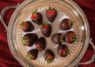One dozen Chocolate Covered Strawberries on a silver plater