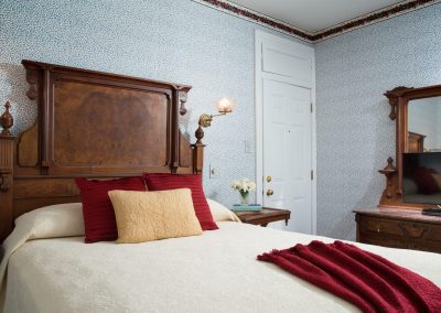 Benjamin Disraeli Guestroom Queen Bed and Antique Dresser