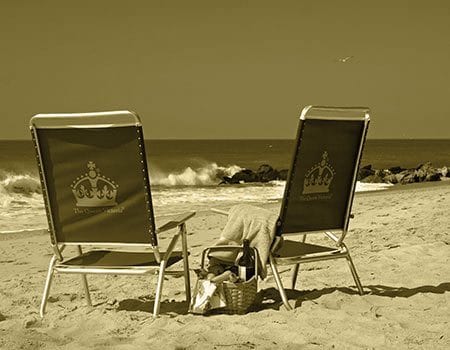 Queen Victoria beach chairs in front of ocean.