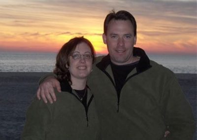 Guest Photos- Smiling couple at sunset near Cape May ocean.