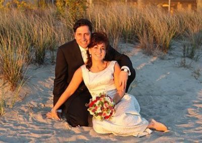 Guest Photos- Wedding picture. Man and woman sitting on sand with flowers