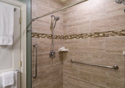 Lord Melbourne Guestroom Step-in Shower with 2 Shower Heads and 3 grab bars.
