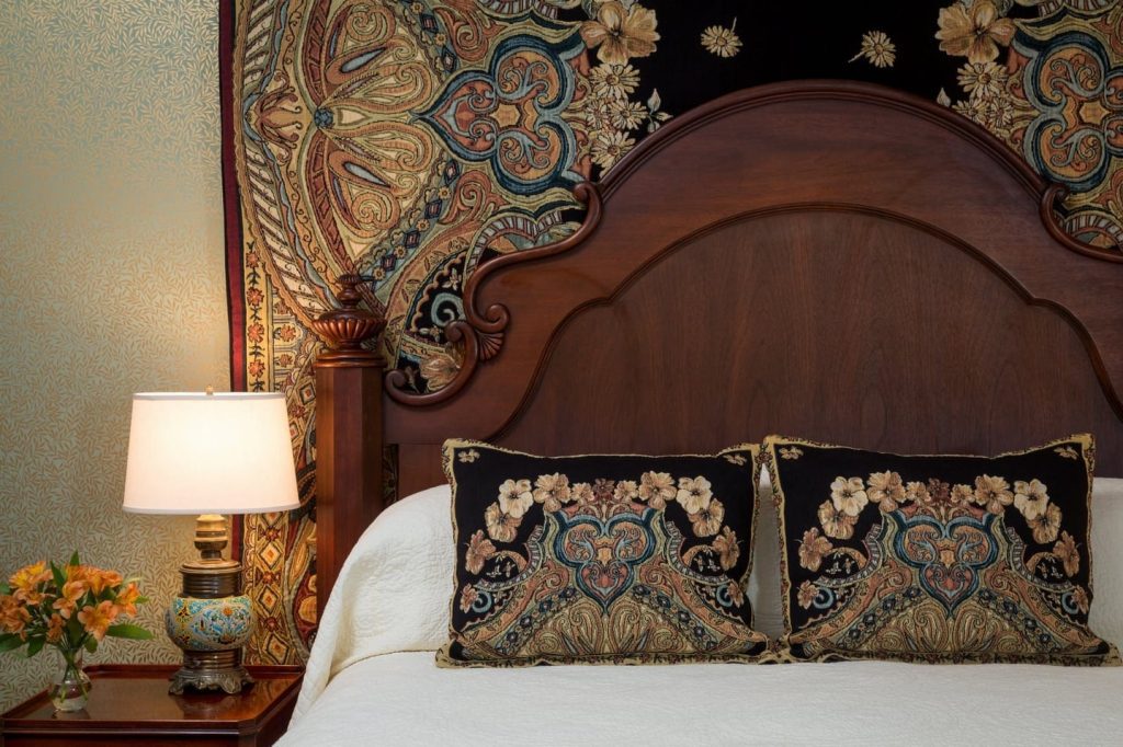 Lord Melbourne Guestroom Headboard with Custom Tapestry and Matching Throw Pillows.